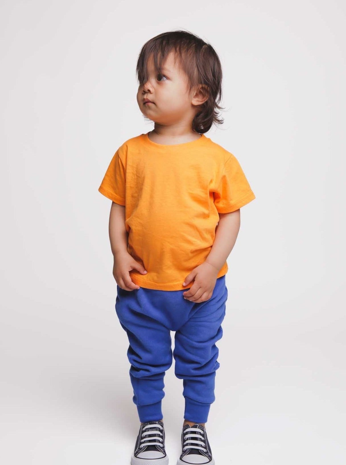 Toddler wearing orange organic cotton kids T-shirt - sustainable kidswear UK