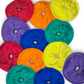 Colorful circular fabric scrunchies arranged in a circular pattern on a white background