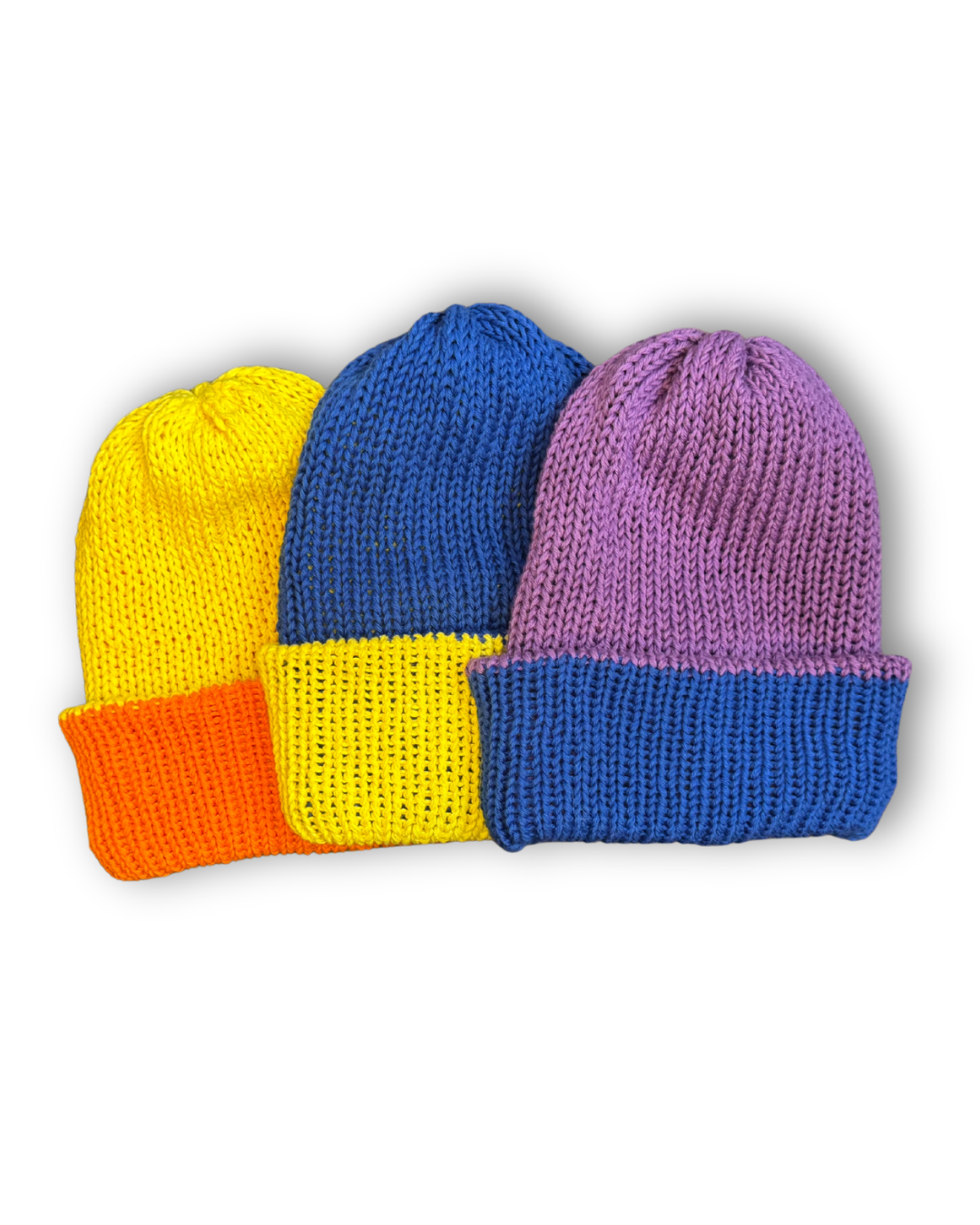 Three handmade reversible cotton beanies in different colour combinations: yellow blue, orange yellow, blue purple