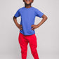A boy wearing a blue t-shirt and red joggers - Hues Clothing
