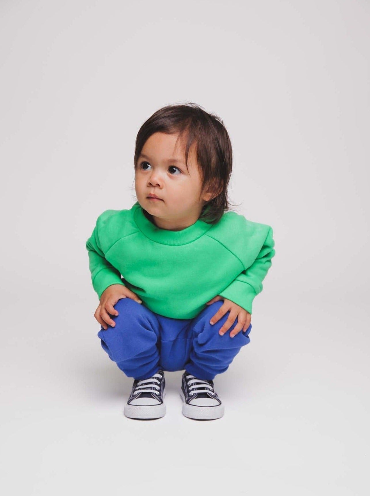 Toddler wearing a green jumper and blue joggers - Hues Clothing