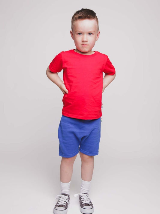 A boy wearing a red t-shirt and blue shorts - Hues Clothing