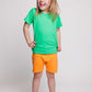 A girl wearing a green t-shirt and orange shorts - Hues Clothing