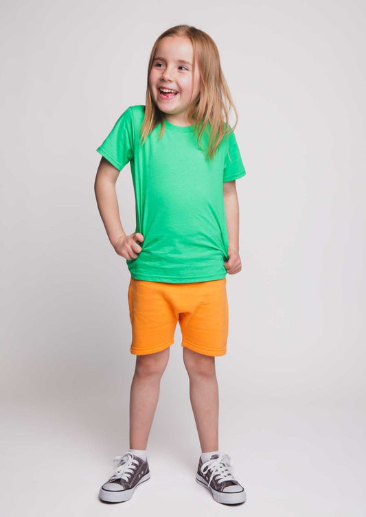 A girl wearing a green t-shirt and orange shorts - Hues Clothing