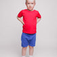 A boy with a short a haircut wearing a red t-shirt and blue shorts - Hues Clothing